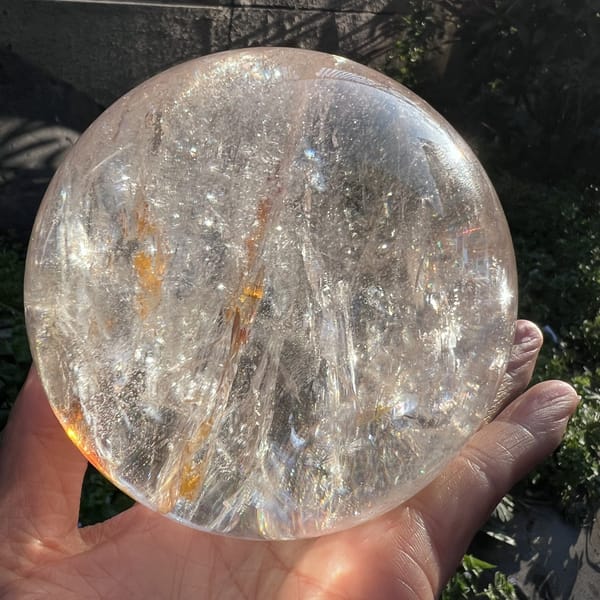 Clear side of the sphere with soft veils and faint golden flecks