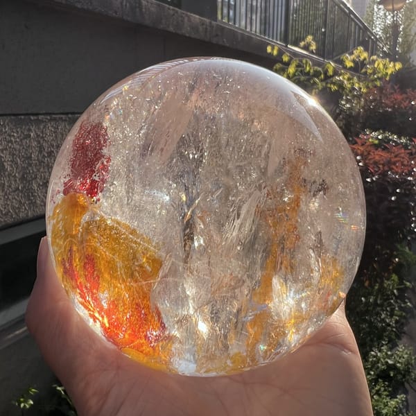 Sphere against a building with the amber inclusion patch at its base