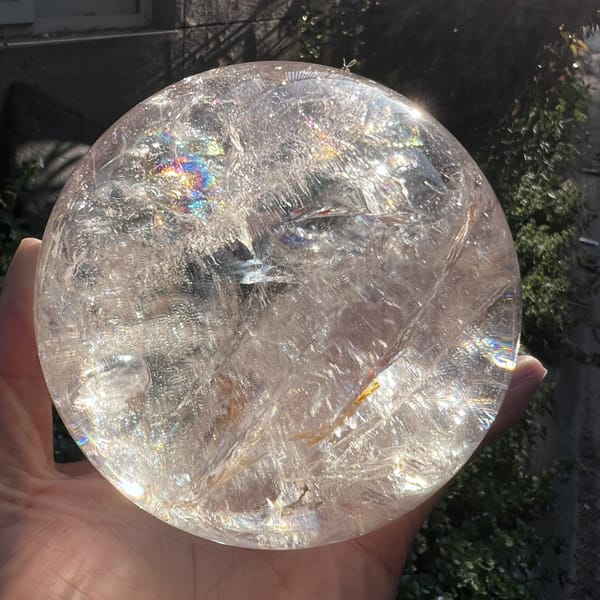 Clear quartz side with a small rainbow near the top