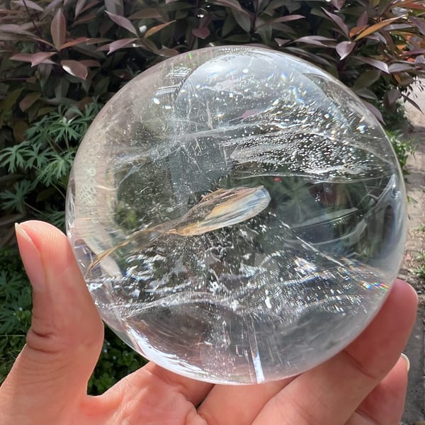 Curled yellow inclusion ribbon lying across the middle of the sphere