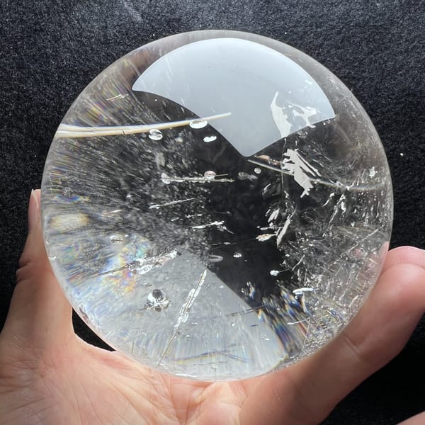 Single long needle crossing the upper half of the transparent sphere