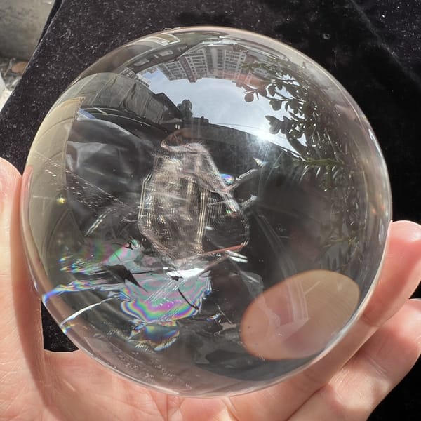 Upright crystal-in-crystal and rainbow patch with a warm reflection at the edge