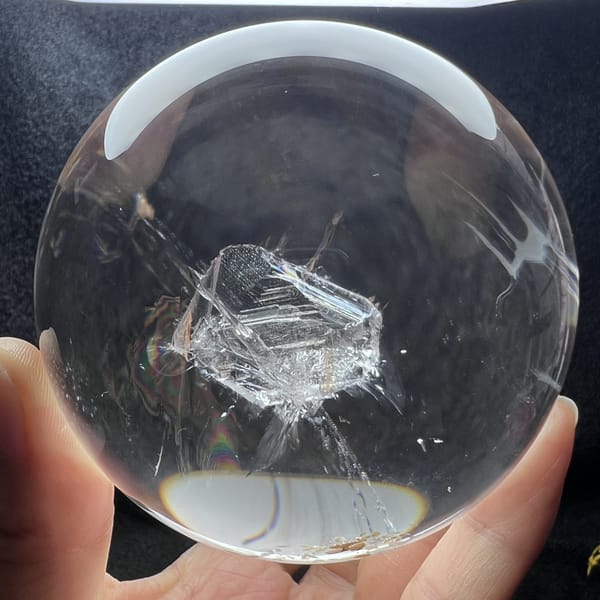 Included crystal seen from above with fine lines and a white reflection