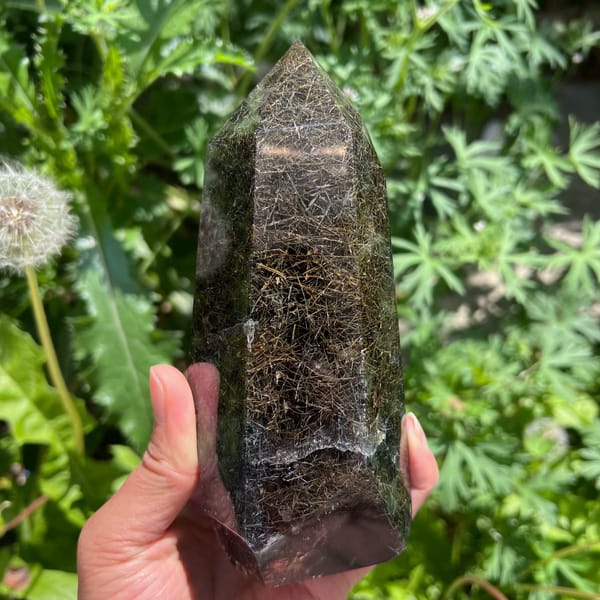 Tower face crowded with fine gold and dark rutile needles