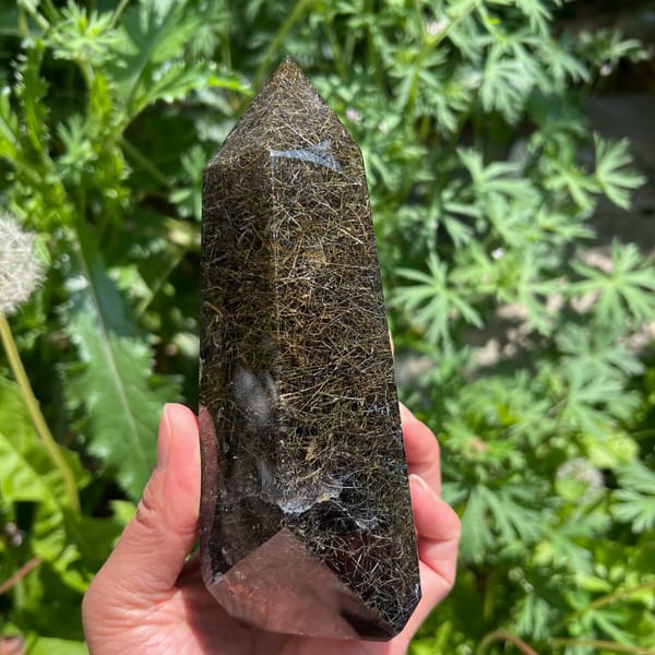 Side view of the tower with criss-crossing golden hairs in dark quartz