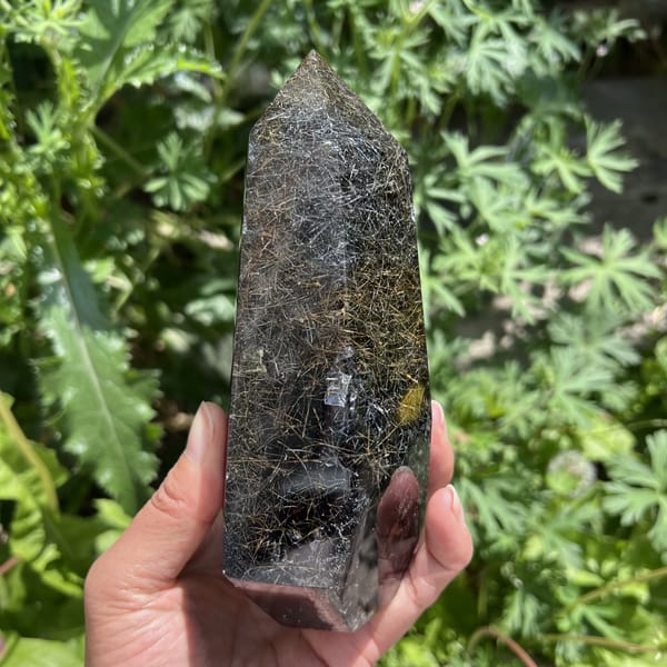 Dark rutile strands near the base of the tower