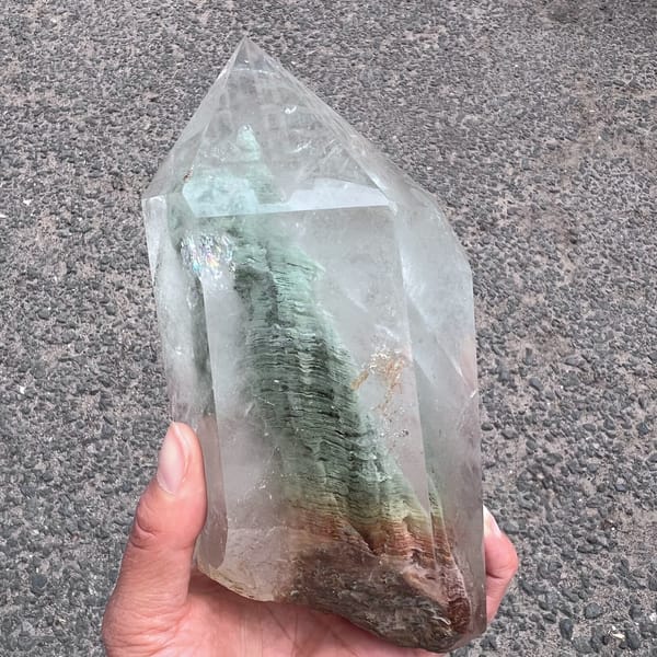 Clear quartz tower with a layered green phantom mountain rising inside