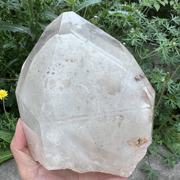 Phantom pyramid face with a small rusty inclusion near the base