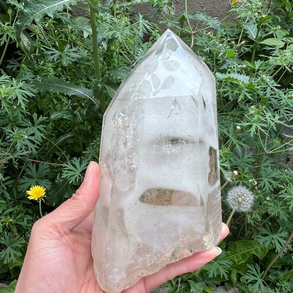 Tall clear quartz phantom tower with stacked grey-green phantom bands