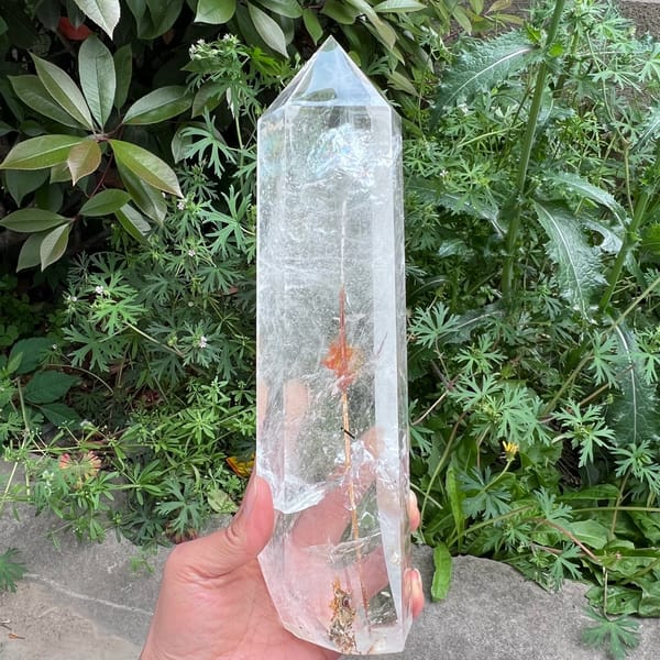 Very tall clear quartz tower with one thick rutile needle inside