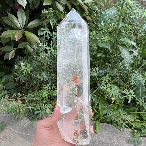 Orange-red rutile burst around the long needle mid-tower