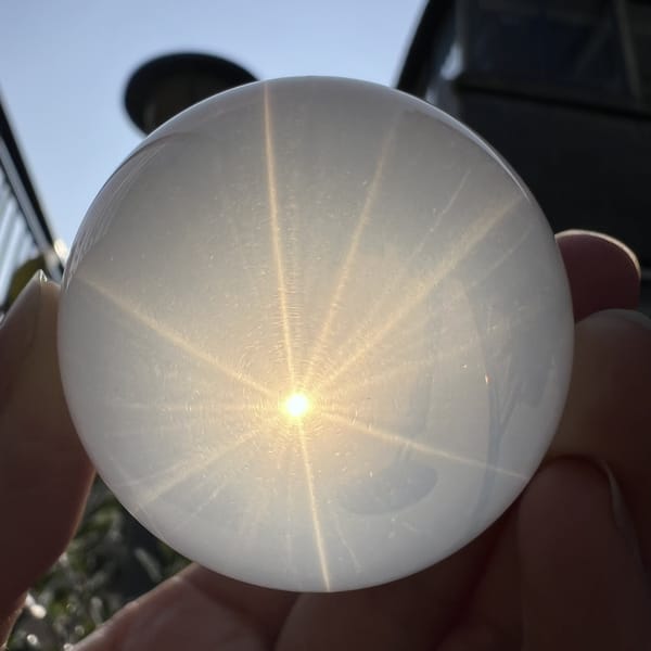 Glowing six-ray asterism with secondary faint stars across the milky quartz