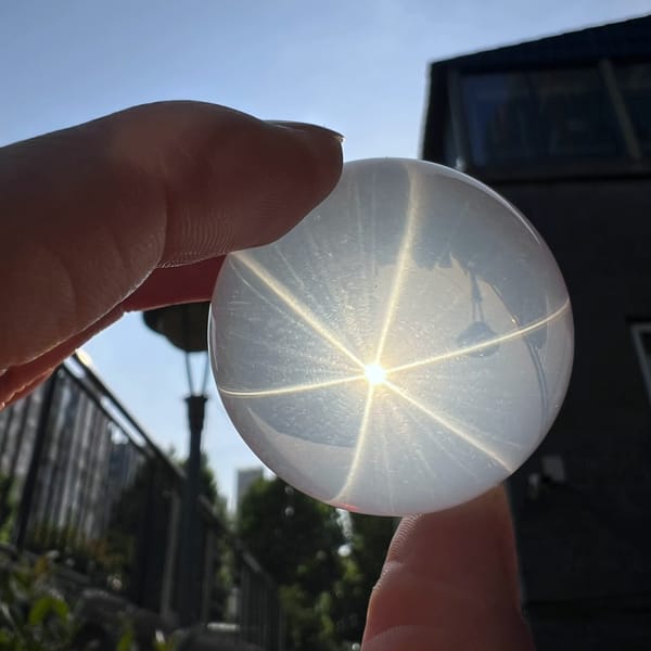 Star sphere between fingers with rays reaching the rim
