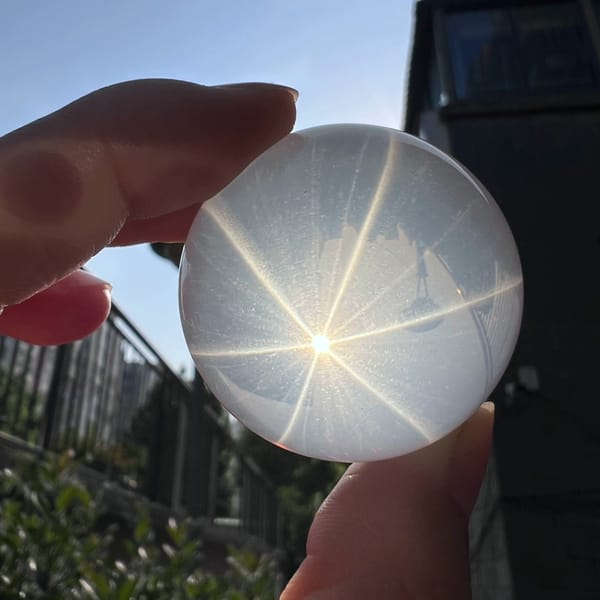Six-ray star on the sphere against a dark building