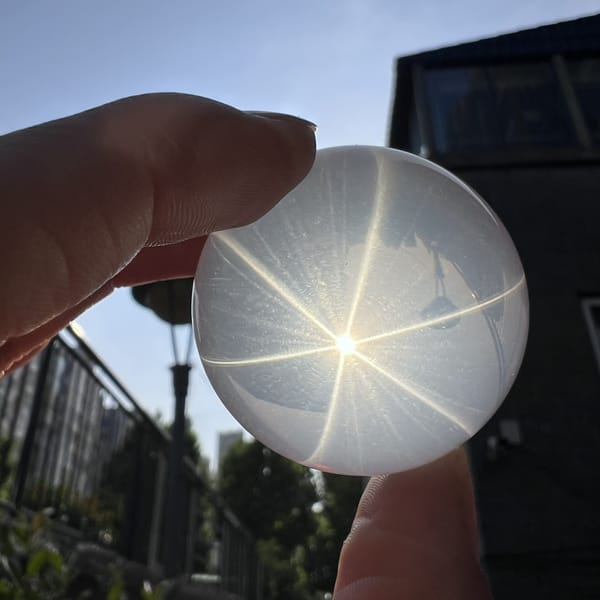 Backlit sphere with bright star and fine rutile shimmer