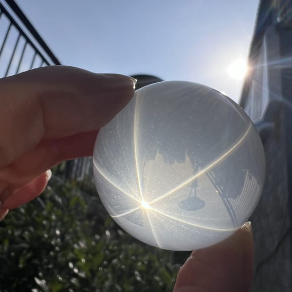 Sun behind the sphere throwing a star near its lower edge