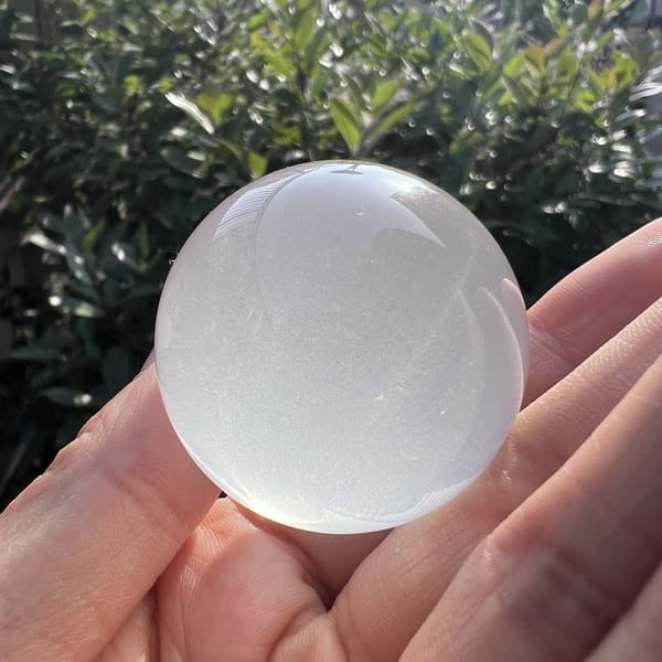 Sphere in hand in daylight showing smooth polished surface
