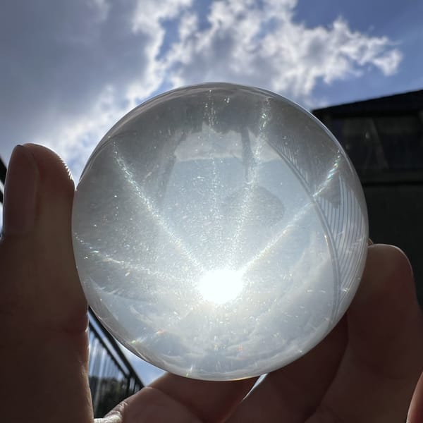 Twelve-ray star under clouds with rays reaching the rim