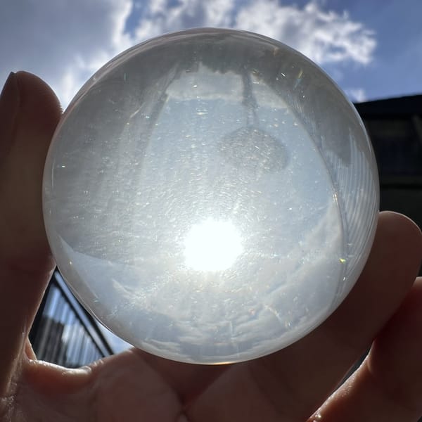Sphere held up to the sky, glowing star and silky haze