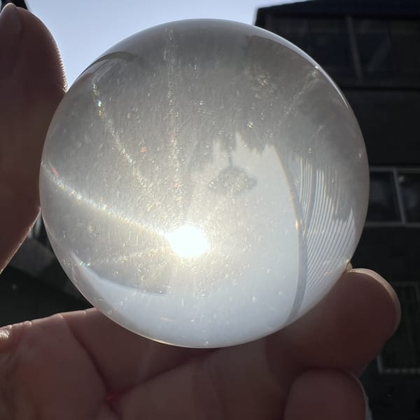 Sphere backlit with a single bright ray across its face