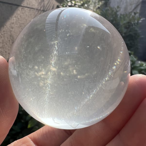 Sphere in hand with one bright band of light across it