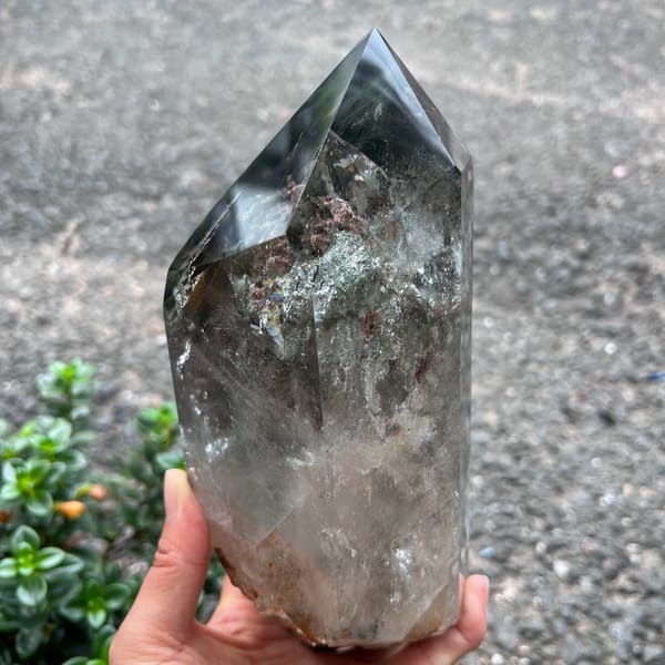 Upper section with dense green and rose phantoms beneath the polished point