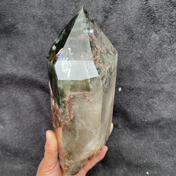 Bright rainbow across an upper face of the polished phantom quartz tower