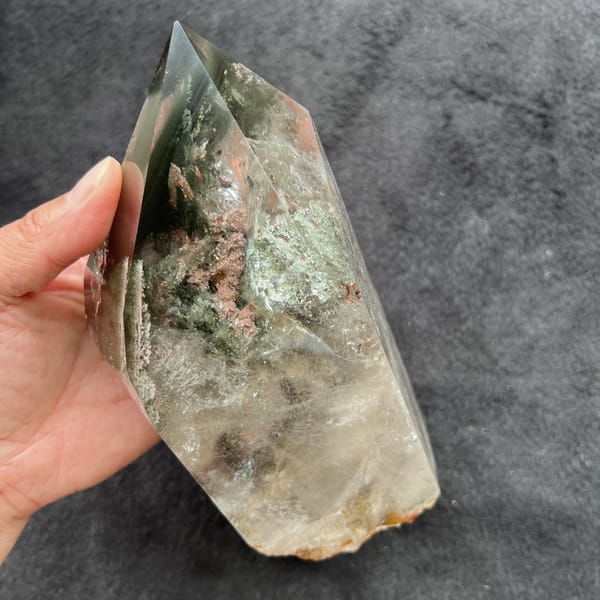 Hand-held side angle with green phantoms and pink flower inclusions near the top