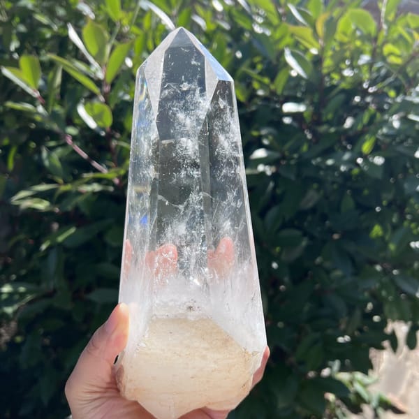 Front view in daylight with faint pink reflections inside the clear quartz