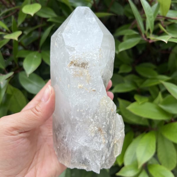 Top section of the point with crust and a small attached crystal