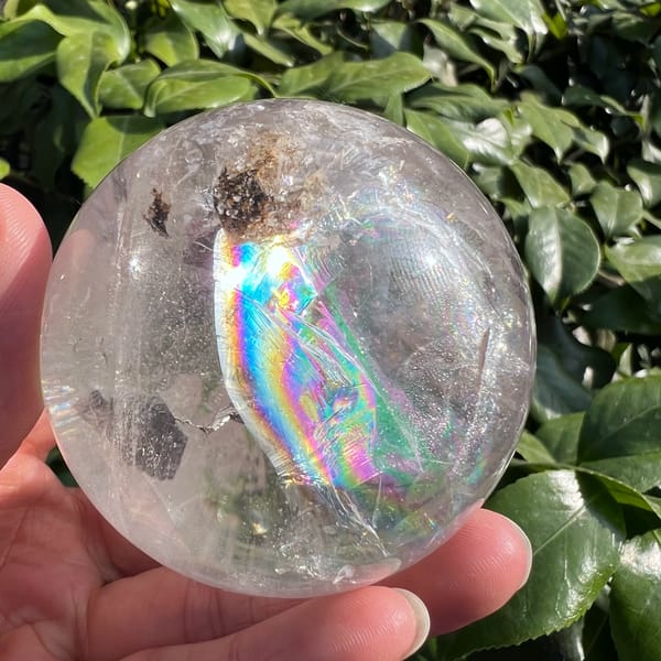 Vivid full-spectrum rainbow arc inside the polished quartz sphere