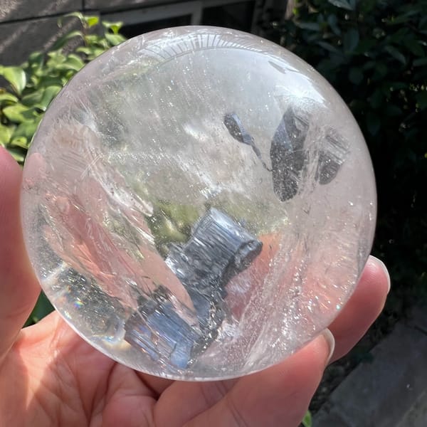 Dark stepped plates and a teardrop-shaped inclusion inside the sphere