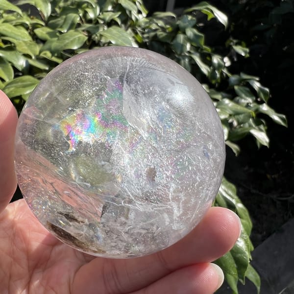 Soft rainbow haze and scattered inclusions in the lower half