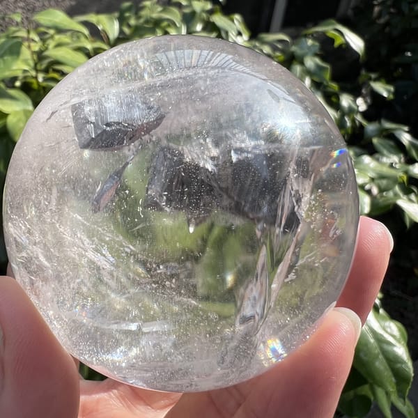 Several dark inclusions clustered across the middle of the sphere