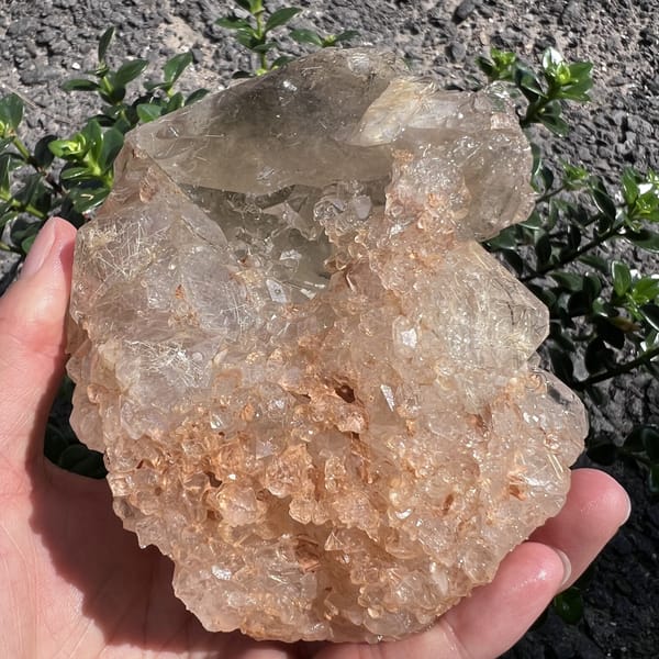 Base of the specimen with granular peach crust and clear quartz above