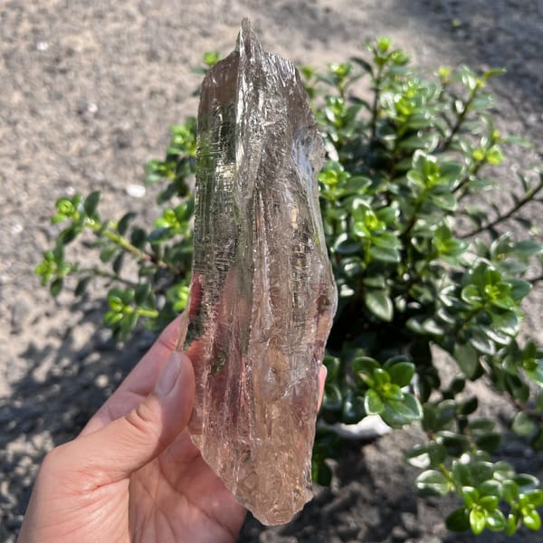 Slim edge view of the crystal showing its uneven natural top
