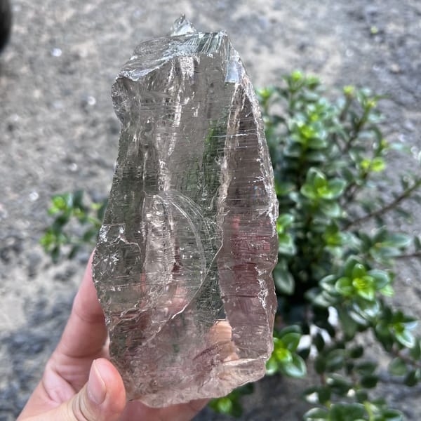 Angled outdoor view of the unpolished smoky crystal's etched surface