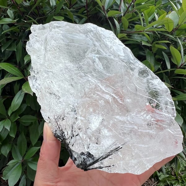 Wide face of the ice block showing black tourmaline sprays fanning out