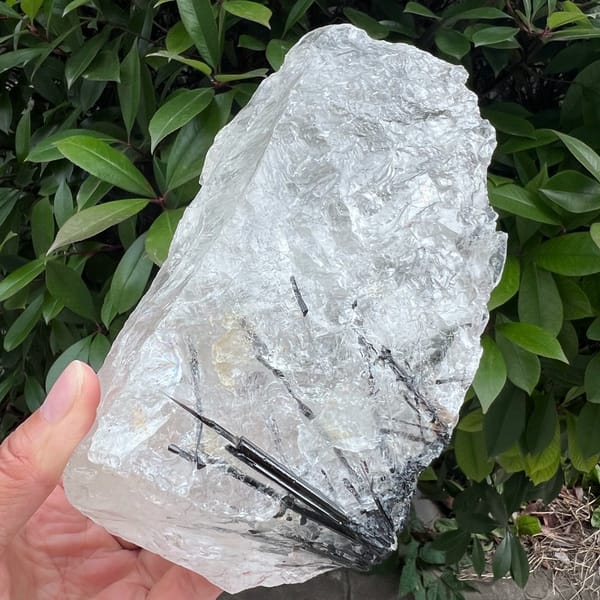 Close angle on splintering tourmaline sprays inside the block