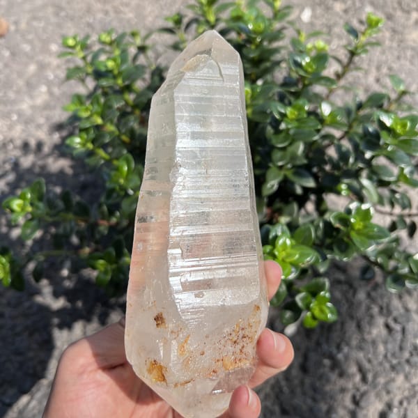 Himalayan quartz with horizontal ridges and a faint greenish interior