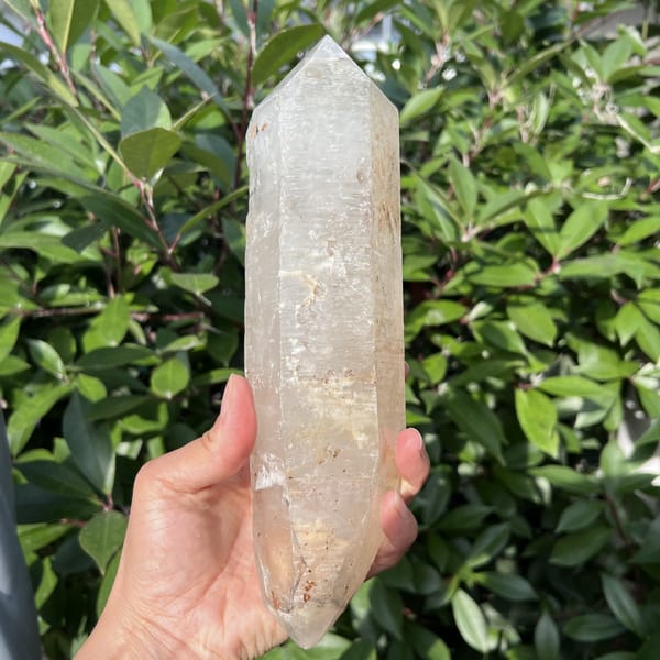 Front view of the long double-terminated quartz with milky veils