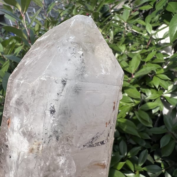 Upper termination of the Madagascar quartz with dark specks inside