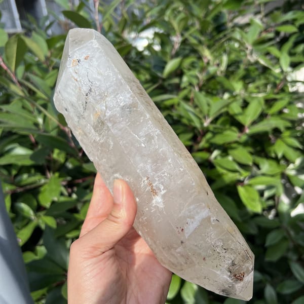 Double-terminated Madagascar quartz held diagonally showing both natural points