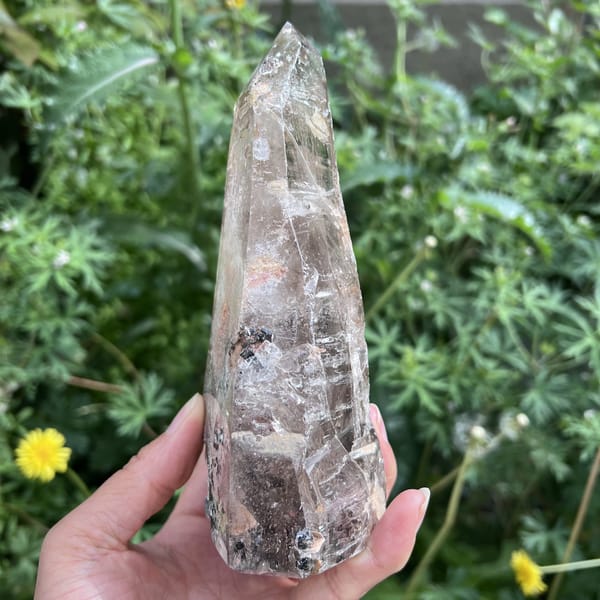 Narrow edge of the quartz point showing tourmaline near the base