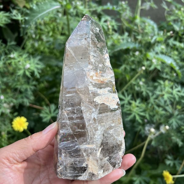 Freeform quartz side face with faint smoky tone and clear tip