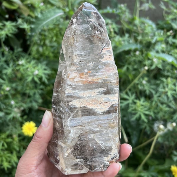 Front view of the freeform clear quartz with layered inclusions