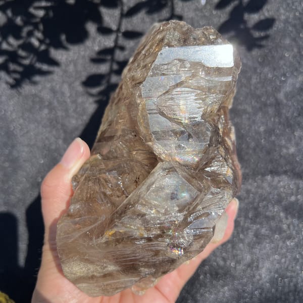 Smoky quartz side showing two stacked window faces and etched surface