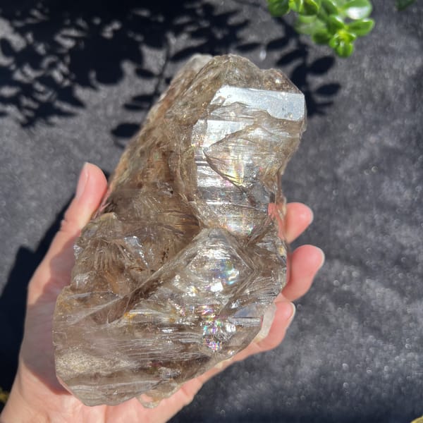 Smoky quartz side with layered windows and a small rainbow