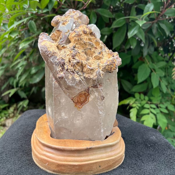 Top crust of the quartz with small attached crystals and orange-brown material