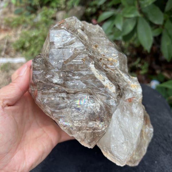 Smoky quartz side showing a rainbow window and milky lower crystal